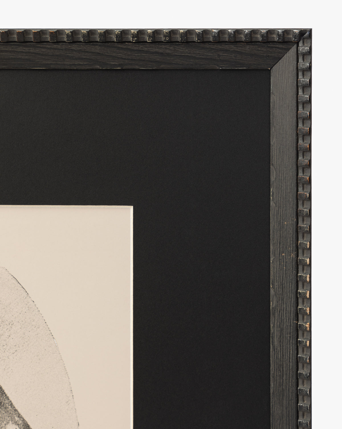Close-up of the top right corner of the Winnie black frame, featuring a textured beaded edge and showcasing part of a matted black and white horse portrait as elegant wall art, by McGee & Co.