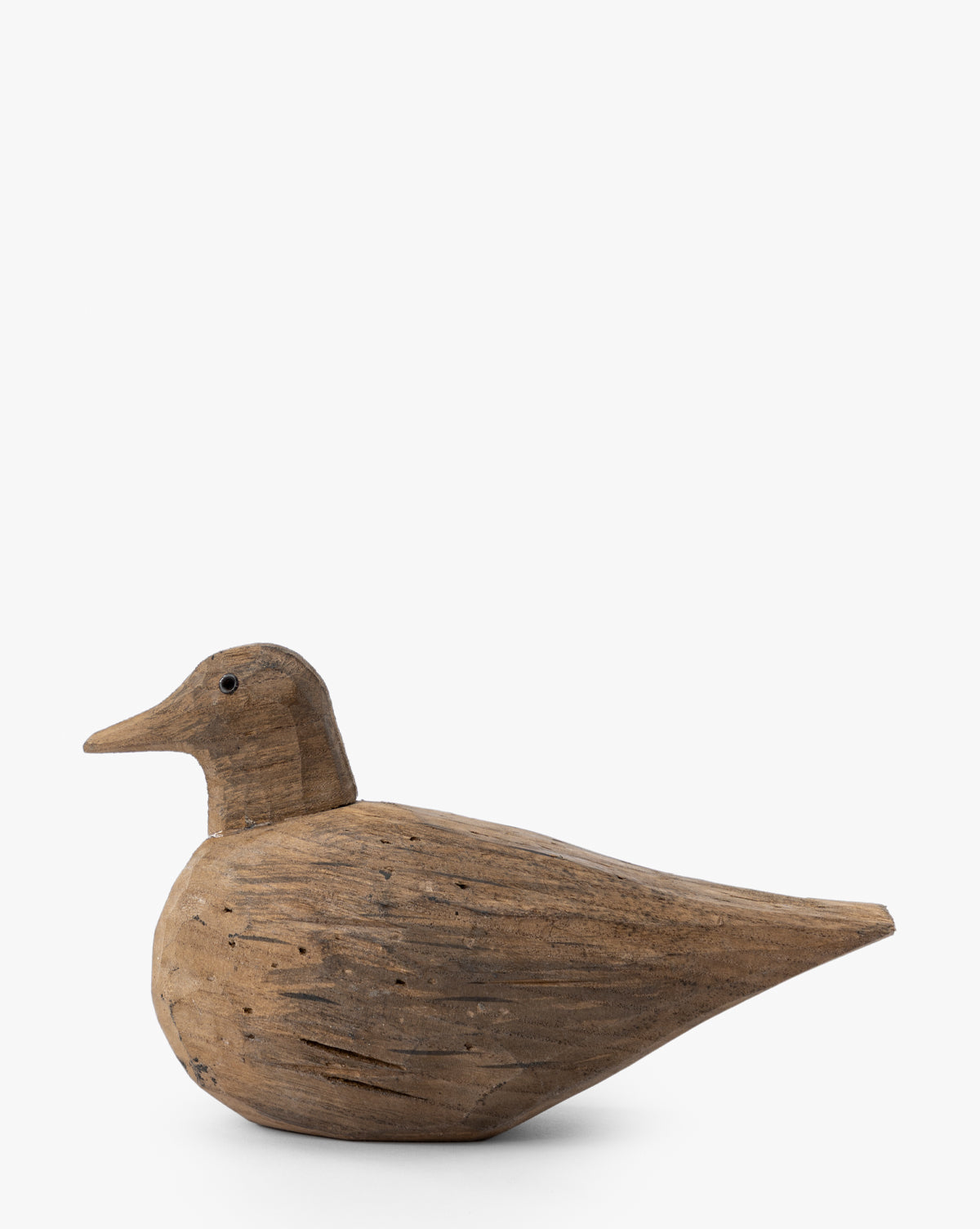 The Wooden Bird Object features a smooth, natural finish with a rounded body, pointed beak, and minimal carved details, shown against a plain white background—making it an ideal nature-inspired piece for unique home decor, by McGee & Co.