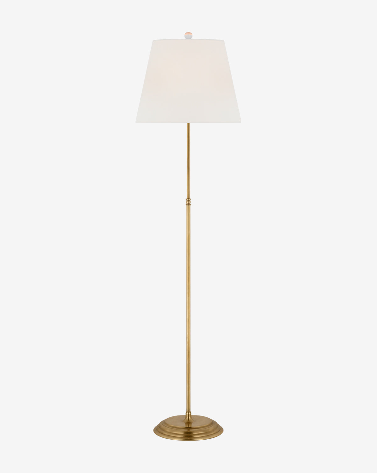 The Wyatt Floor Lamp boasts a slim gold metal stand, round base, and white linen shade for a modern, elegant look, perfect as a stylish accent in any space, by McGee & Co.