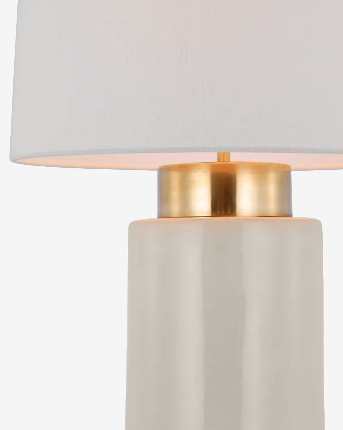 Close-up of the Xian Table Lamp, featuring a modern white ceramic base, gold accent near the top, and a crisp white linen shade, by McGee & Co.