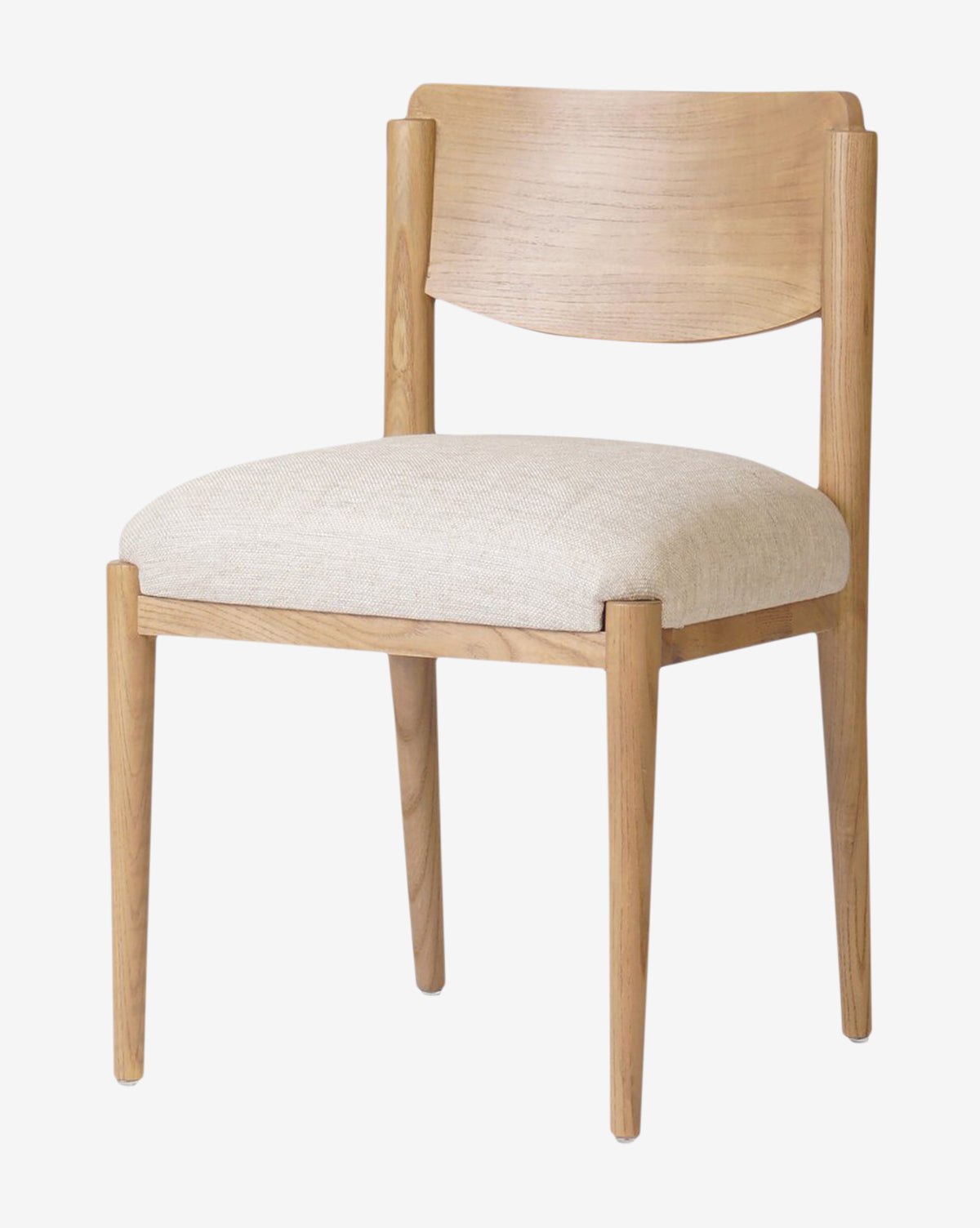 The Reverie Dining Chair has a modern light wood frame, a curved backrest, and a beige upholstered seat cushion, presented on a plain white background by McGee & Co.