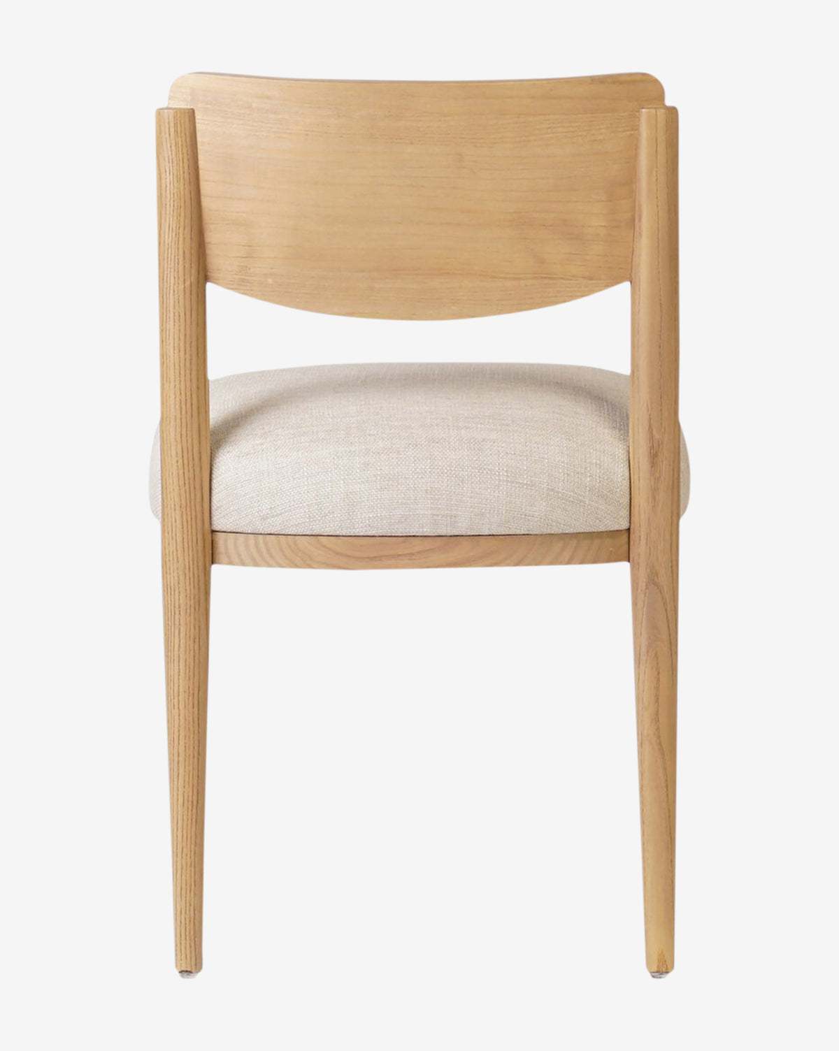 The Reverie Dining Chair showcases a wood frame, curved backrest, and light beige upholstered seat cushion, shown from behind against a plain white background by McGee & Co.